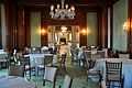 A banquet room with wood and green-paneled walls