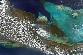 View from the air of coastline, sea and vegetation-covered land