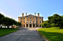 Single facade of a three-story beige Renaissance Revival mansion