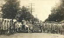 A fire department group photograph showing members and vehicles