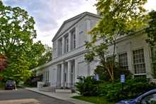 A two-story white Neoclassical school building