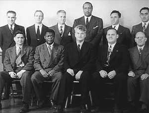 Eleven well-dressed men, seated for a formal photograph.