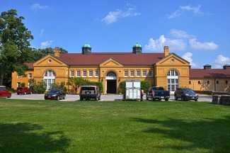 A large classical two-story tan-brick building