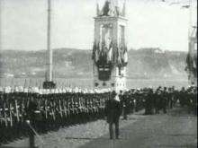 George in military dress uniform hands out medals to servicemen, rides in a carriage and inspects a guard of honour