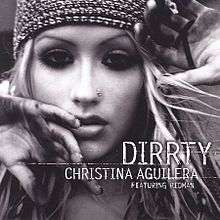 Picture with the words "DIRRTY CHRISTINA AGUILERA FEATURING REDMAN" under the image of a blonde woman's face. She has a nose earring, a tight fitting cap, and mascara-darkened eyes. Her hands are partially blocking the view of her face.