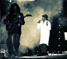 Singer and guitarist in front of effects smoke