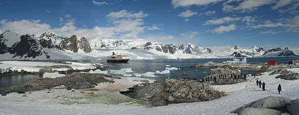 Cruise ship at Petermann Island, with the Kiev Peninsula of Graham Land in the background.