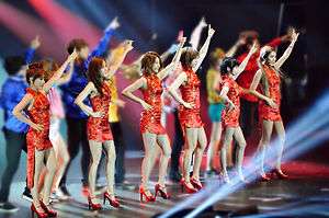 A group of six ladies wearing red cheongsam performing onstage