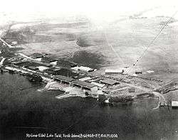 Aerial photo of shoreline buildings and docks