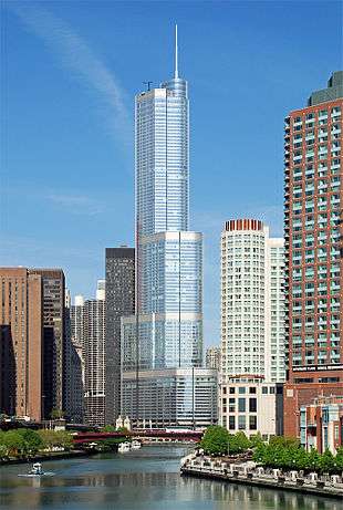 View of a tall building at a bend in the river.