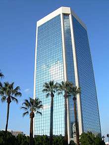 low angle shot of modern all glass office building in downtown Phoenix.