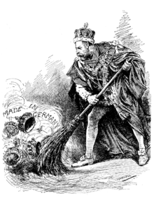 George V dressed in the ceremonial robes of the Order of the Garter uses a broom to sweep aside assorted crowns labelled "Made in Germany"