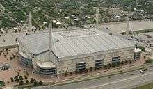 Aerial image of a rectangular building with towers pointing skyward in each corner of the building.