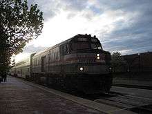 Locomotive leading passenger train into station