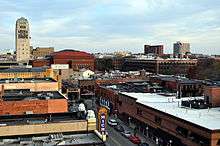 Aerial view of a city downtown, showing the Michigan Theater and a Borders in the foreground, and several buildings amongst trees in the background