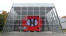 The red metal chassis of the ARGUS detector exposed in a dedicated glass hall