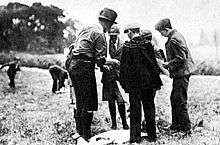 black and white photo of a man and boys in action