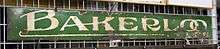 A green metal sign with the words "Bakerloo Tube" on it.