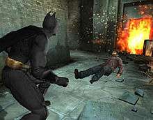 Batman is shown at the left side of the screen, ready to fight. The target is a prone figure on the other side of the screen.