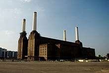 Photo of a large building with four tall chimneys.