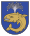 A coat of arms depicting a sea creature with sharp teeth, one protruding bottom tooth, and a blowhole spewing water