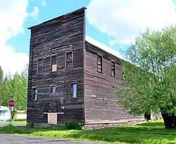 Photograph of the Bovill Opera House, a three-story, wooden building with a false front