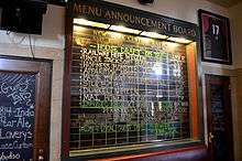 Blackboard with labels for names of train and destinations, but lists names of beers and other beverages instead