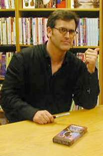 A man sitting at a table with a VHS on the table.