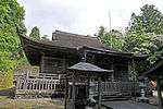 Wooden building with a hip-and-gable roof.