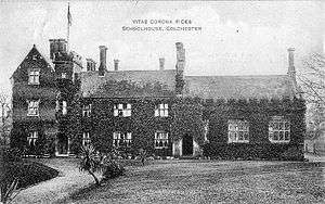 An ivy-covered brick building, photographed in black and white