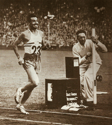 A black and white photo of a track athlete wearing the number 23 running.