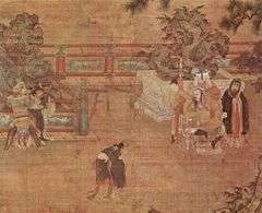 A painting of a play being staged in a courtyard. In the center, a man in loose black robes appears in mid-bow or mid-dance. To the left, two men dressed as guards are holding a third man, dressed in the same attire as the man in the center. To the right, a heavy set man sits in a throne. Behind him stand three women in white face paint and a man dressed in the same attire as the man in the center.