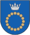 A coat of arms depicting a circle for which the boundary is itself made up of beige circles all under a silver crown on a blue background