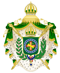 Coat of arms consisting of a shield with a green field with a golden armillary sphere superimposed on the red and white Cross of the Order of Christ, surrounded by a blue band with 20 silver stars; the bearers are two arms of a wreath, with a coffee branch on the left and a flowering tobacco branch on the right; and above the shield is an arched golden and jeweled crown