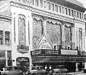 Tall building with a marquee featuring production of “Dance of Life”.