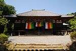 Wooden building with raised floor and a wide staircase.