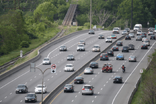 A photograph of a freeway curving and rolling with the landscape.