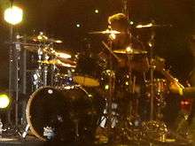 Woodgate sitting at a drum kit