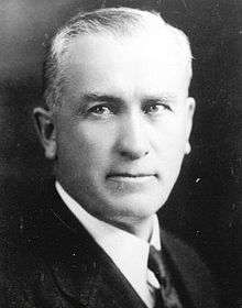 A head-shot of a white-haired man