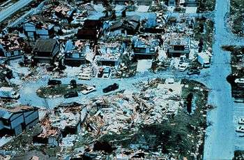 A close-up view of houses with evident wind damage