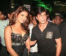 Shah Rukh Khan standing beside Priyanka Chopra at film premiere