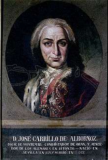 Smiling man in white wig and red cloak