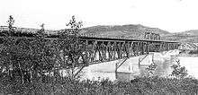 A tressed railway bridge over a river