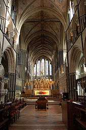 View into the chancel at Worcester shows both the building and its fittings. As at Salisbury, the columns are detailed with Purbeck shafts. The east end has a group of five simple lancet windows, stepped to fit the arch of the vault, which is richly decorated with paint. The floors are black and terracotta tiles. Behind the altar, with its brightly coloured modern embroidered frontal, rises a 19th-century reredos, designed to harmonise with the windows.