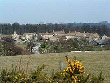 Village, seen from a distance across a field