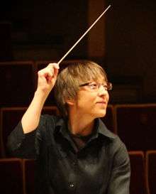 Ewa Strusinska conducting an orchestra