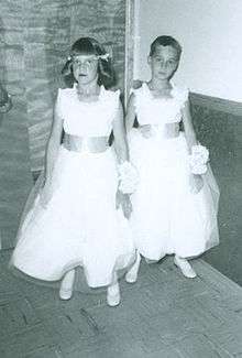 two young children dressed as flower girl/boy for a wedding.