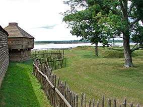 Log structure inside palisade fence