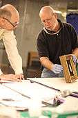 Frame conservator examining frame