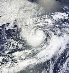 A visible satellite image of a small hurricane in the open Pacific.